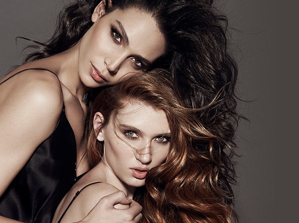 Two women with brushed hair, brown and redhead