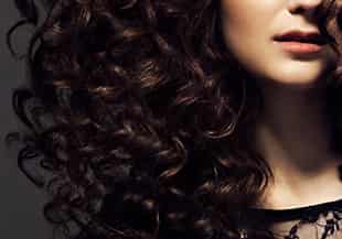 A woman with curly brown hair