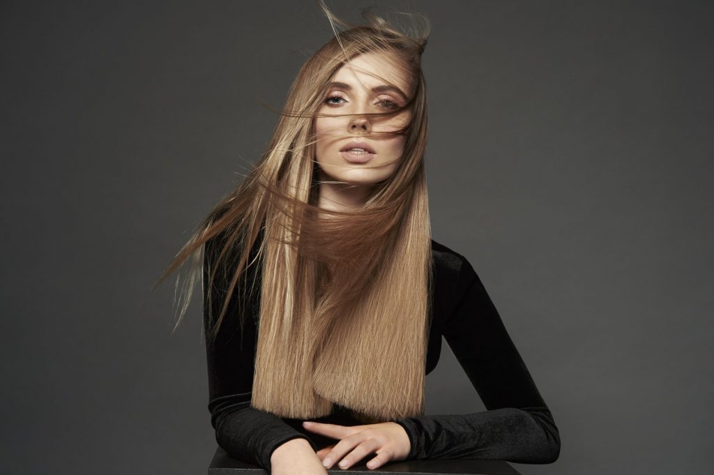 Woman with long blond straight hair.