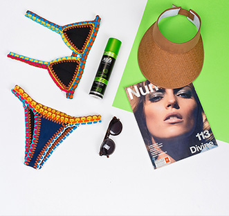 Swimsuit, a bottle of Natural Formula, sunglasses, hat and magazine